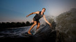 © fesenko - Active strong young man riding down the river waves in evening