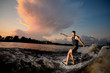 © fesenko - Active man riding on wakesurf down the river
