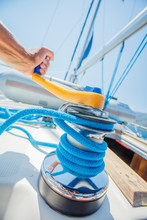 Hand Of Captain Sail Boat Working On The Boat With Winch On A Sailboat. Yacht Tackle During The Ocean Voyage, Sailing Concept. Outdoors Horizontal Colored Closeup Image