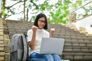 Business Concepts. Beautiful girl playing computer in the building. Beautiful businesswoman succeeds in working.