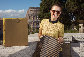 Wall Mural - smiling modern tourist woman in Rome, Italy with shopping bags