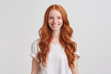 Closeup Of Happy Pretty Redhead Young Woman With Long Wavy Hair And Freckles Wears Stylish T Shirt Feels Satisfied And Looks Confident Isolated Over White Background