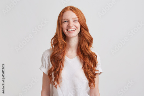 Portrait of cheerful cute redhead young woman with long wavy hair and freckles w Tableau sur Toile