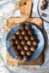 Wall Mural - Raw vegan sweet balls with dates, coconut, cocoa powder, cocoa butter, banana and nuts. Vegetarian truffel dessert with carob powder.