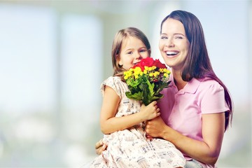 Wall Mural - Portrait of happy mother and daughter holding