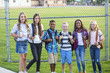 © Brocreative - Group of school kids smiling while standing together in an elementary school playground. Back to school photo