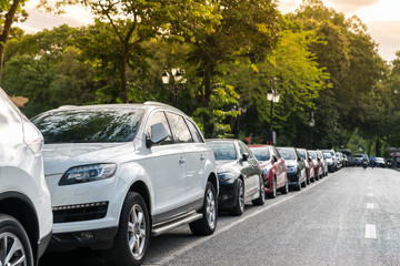 Wall Mural - Parallel parking cars on urban street. Outdoor parking on road