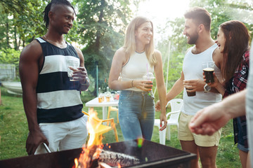 Wall Mural - Group of friends making barbecue in the backyard. concept about good and positive mood with friends