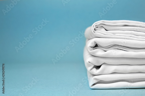 Cuadros en Lienzo Stack of clean bed sheets on color background