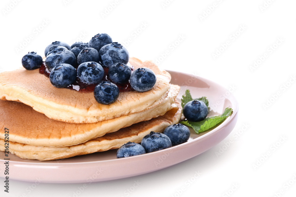 Plate with tasty pancakes and blueberries on white background, closeup