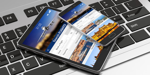 Smartphone and tablet on a computer keyboard, Search flights on the screens. 3d illustration
