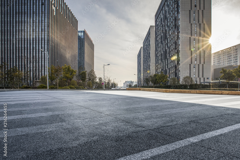 Panoramic skyline and modern business office buildings with empty road,empty concrete square floor - obrazy, fototapety, plakaty 