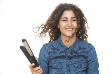 Beautiful young girl with curly hair and hair iron straightener isolated studio on white