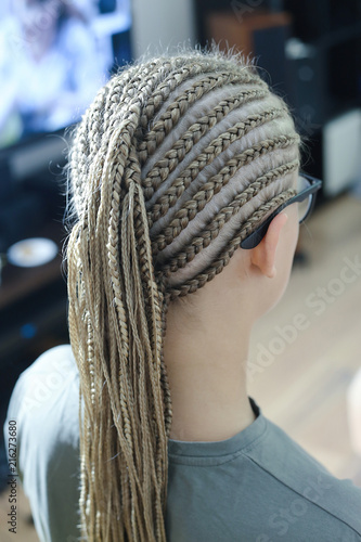 beauty services, a lot of thin color braids on the head