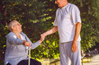 © Lucky Fenix - pensioner man supporting ill wife in the park.