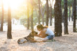 © SB Arts Media - Young attractive latin woman teaching and loving her beautiful cute german shepherd dog in the park at sunset in nature care support happiness peaceful friendship training animals lifestyle concept.