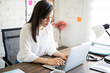 © AntonioDiaz - Latin businesswoman working at her desk