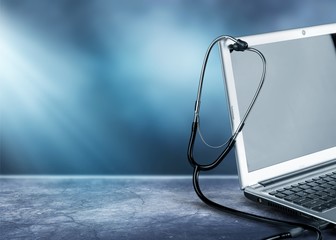 Poster - Laptop diagnosis with  stethoscope on background