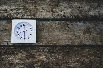 Wall Mural - White clock on the wooden floor in the morning.On the floor there is a watch on it.