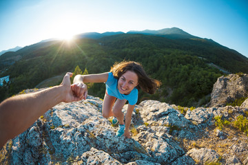 a girl is climbing a stone.