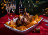 Fototapeta  - Grilled guinea-fowl with mandarins in white form for cooking with New Year's details