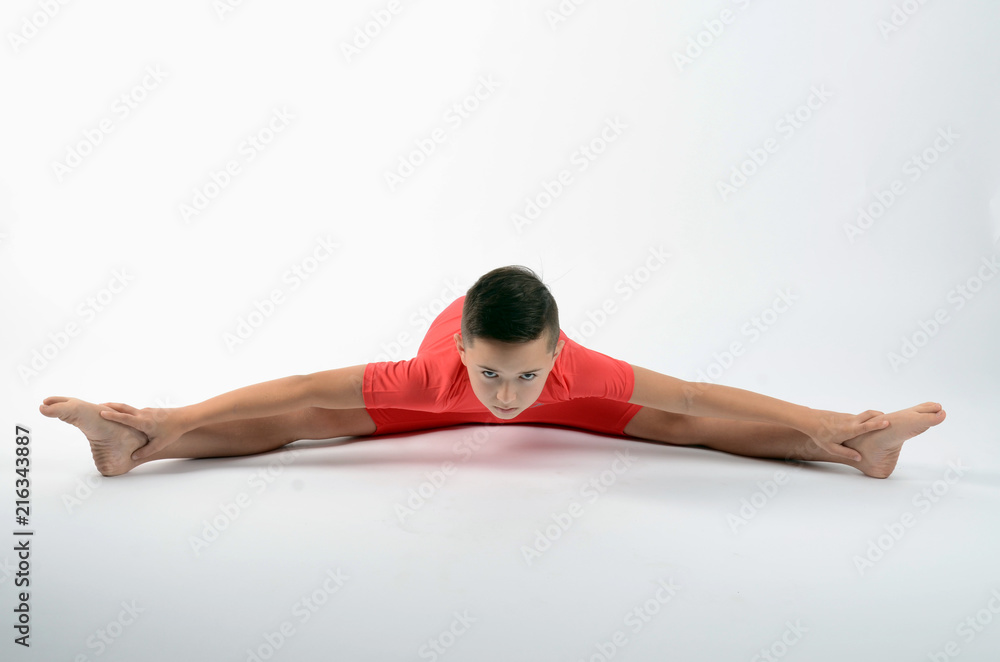 Male child gymnast performing the splits Stock Photo | Adobe Stock