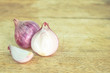 red onion sliced on wooden cutting board
