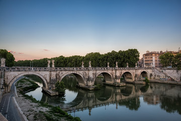 Wall Mural - Pont St Angelo reflected in the Tiber river in Rome, Italy