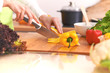 © rogerphoto - Close Up of human hands cooking vegetable salad in kitchen on the glass table with reflection. Healthy meal, and vegetarian food concept