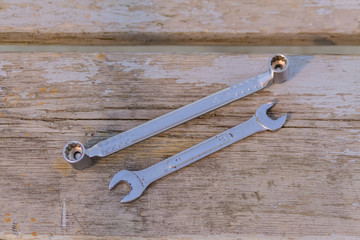 Wall Mural - two metal wrenches on wooden background. Set of worktools for maintenance and repair