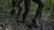 People Running A Mud Race High Speed And Slow Motion