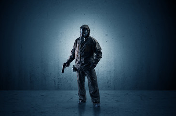 Wall Mural - Bad agent in a dark room with arms on his hand and gas mask
