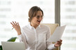 © fizkes - Happy businesswoman excited by good news reading company financial report, female employer surprised with growing rates and sales on document, woman boss satisfied with corporate business success