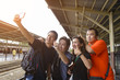 © brostock - Group of four friends selfie with a smart phone in a train station in summer