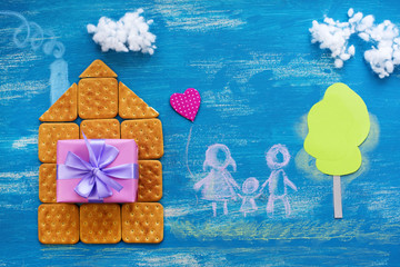  The concept of a cookie house on a wooden blue sky cloud background family path.
