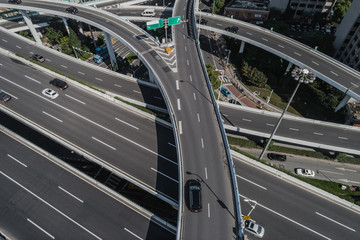 Wall Mural - Aerial view of highway and overpass in city on sunny day