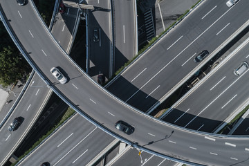 Wall Mural - Aerial view of highway and overpass in city on sunny day