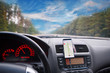 © Tricky Shark - View from inside a car on dashboard with smartphone. mobile phone with gps navigation fixed in the mounting. App map for travel.