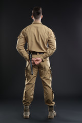 Wall Mural - Male security guard in uniform on dark background