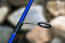 Fishing Rod Spinning Ring With The Line Close-up. Fishing Rod. Rod Rings Selective Focus And Shallow Depth Of Field .Fishing Tackle. Fishing Spinning Reel.