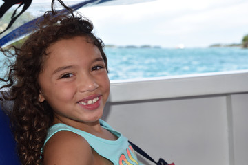 Young girls smiles on a boat in the Philippines