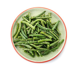 Plate with tasty green beans on white background