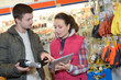 © auremar - attractive harwarestore employee with customer