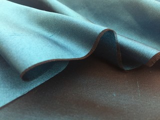 woven texture of silk fabric or yarn turquois beige color changeable for background. advertising cop