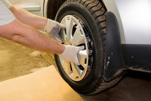 A Mechanic Removing The Hubcap From A Car Wheel. Tire Fitting. Tire Service.