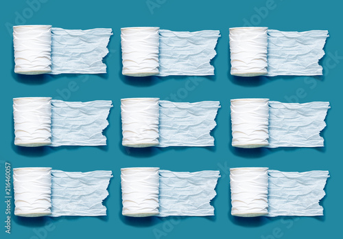 綺麗に並んだたくさんのトイレットペーパーを深い青緑の背景の上に置く Stock Photo Adobe Stock