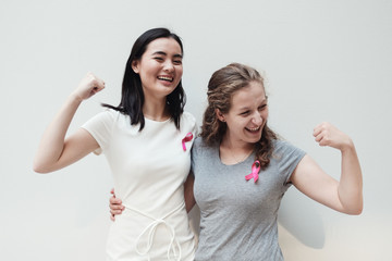 Wall Mural - multiethnic young women with pink ribbons, breast cancer awareness, October pink, world cancer day concept