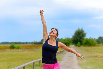  Happy woman cheering and celebrating after working out jogging