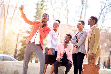 Wall Mural - positive students are taking selfie in the street after studing at the acadamy. free time. selfie time