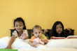 © Sirirat Makprasert - childden are enjoying funny time indoor in modern yellow bed room.